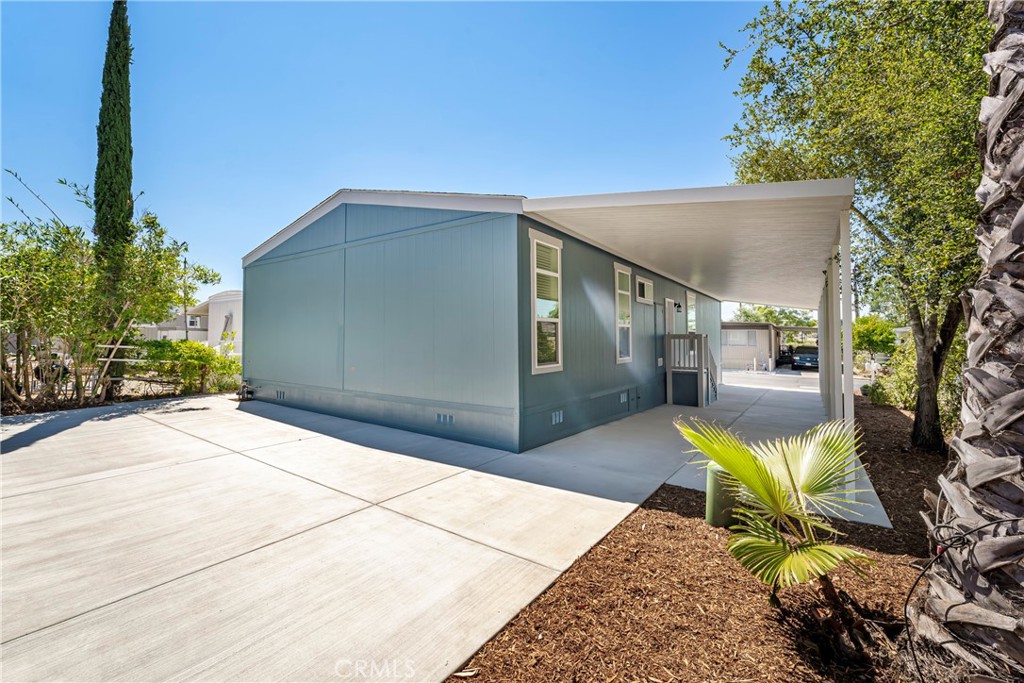 1120 East Mission Road, Unit 57 Fallbrook, CA 92028 - Photo 18 of 25 a view of a chair and tables in the patio