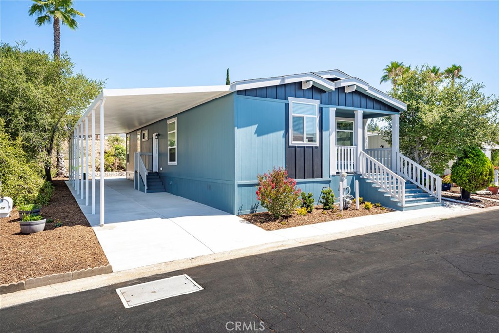 1120 East Mission Road, Unit 57 Fallbrook, CA 92028 - Photo 2 of 25 a front view of a house with a yard
