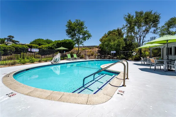 a view of swimming pool with chairs