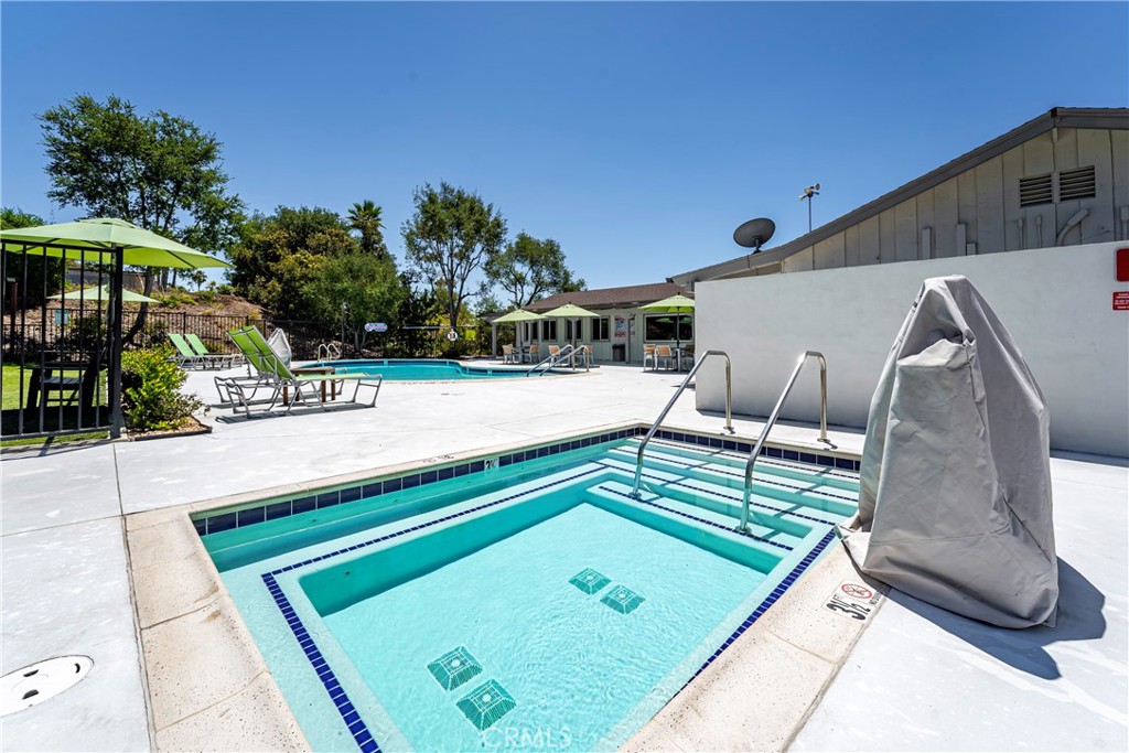 1120 East Mission Road, Unit 57 Fallbrook, CA 92028 - Photo 24 of 25 a wooden bench sitting in front of a building