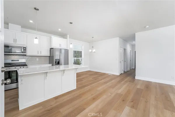 a large kitchen with stainless steel appliances granite countertop a stove a sink and a refrigerator