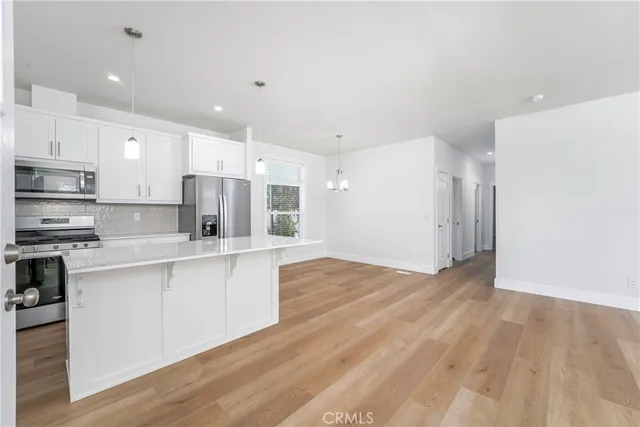 a large kitchen with stainless steel appliances granite countertop a stove a sink and a refrigerator