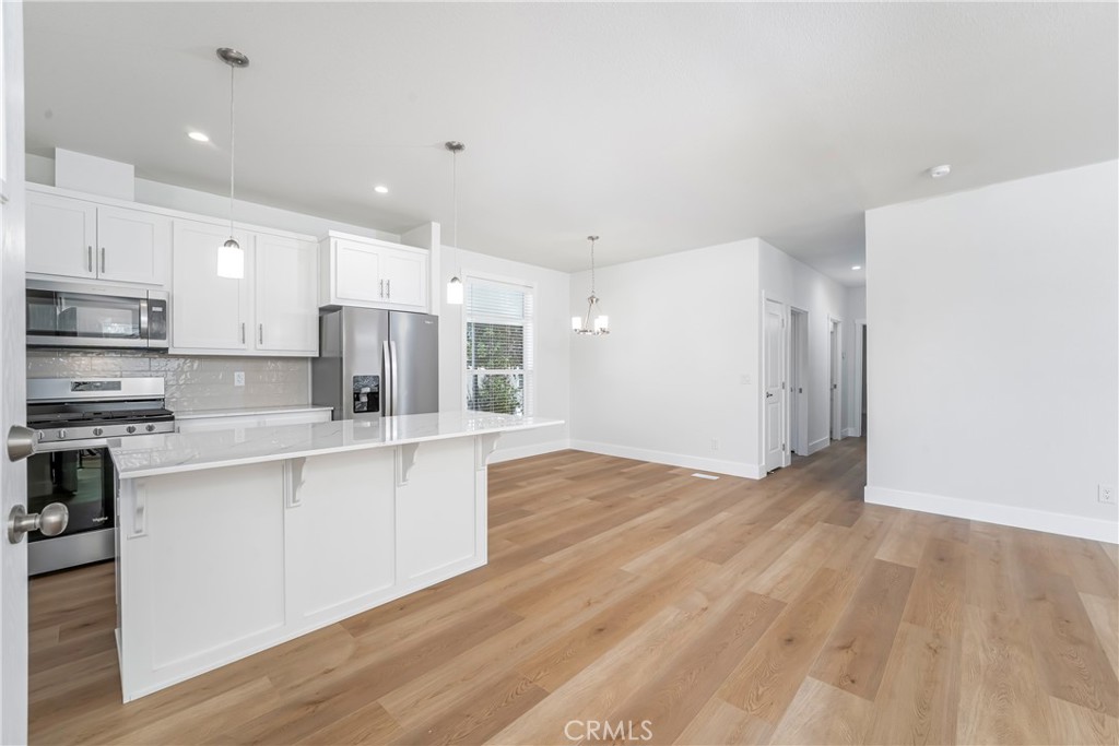 1120 East Mission Road, Unit 57 Fallbrook, CA 92028 - Photo 6 of 25 a large kitchen with stainless steel appliances granite countertop a stove a sink and a refrigerator