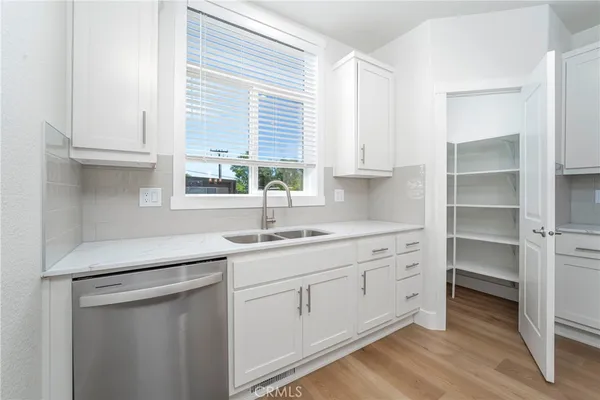 a kitchen with white cabinets and a sink