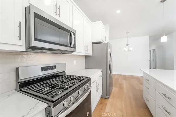 a kitchen with a stove and a microwave