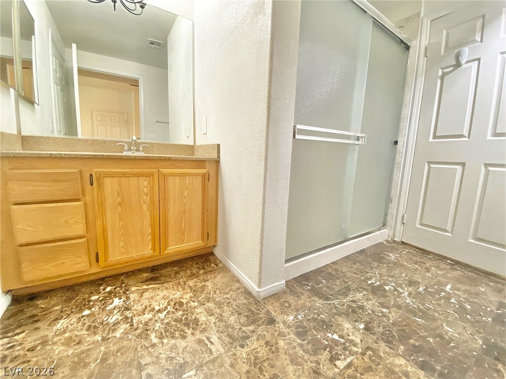 10550 West Alexander Road, Unit 1131 Las Vegas, NV 89129 - Photo 14 of 18 A well-appointed bathroom with ample vanity space and a convenient shower.