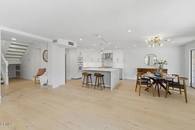 a living room with furniture and kitchen view