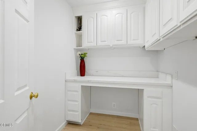 a view of a patio with a table and chairs under an umbrella