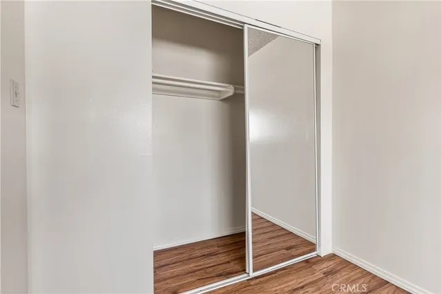a view of walk in closet with wooden floor