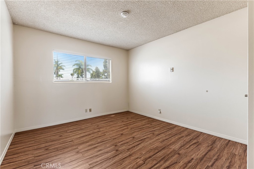 5530 Ackerfield Avenue, Unit 206 Long Beach, CA 90805 - Photo 13 of 33 an empty room with wooden floor and windows
