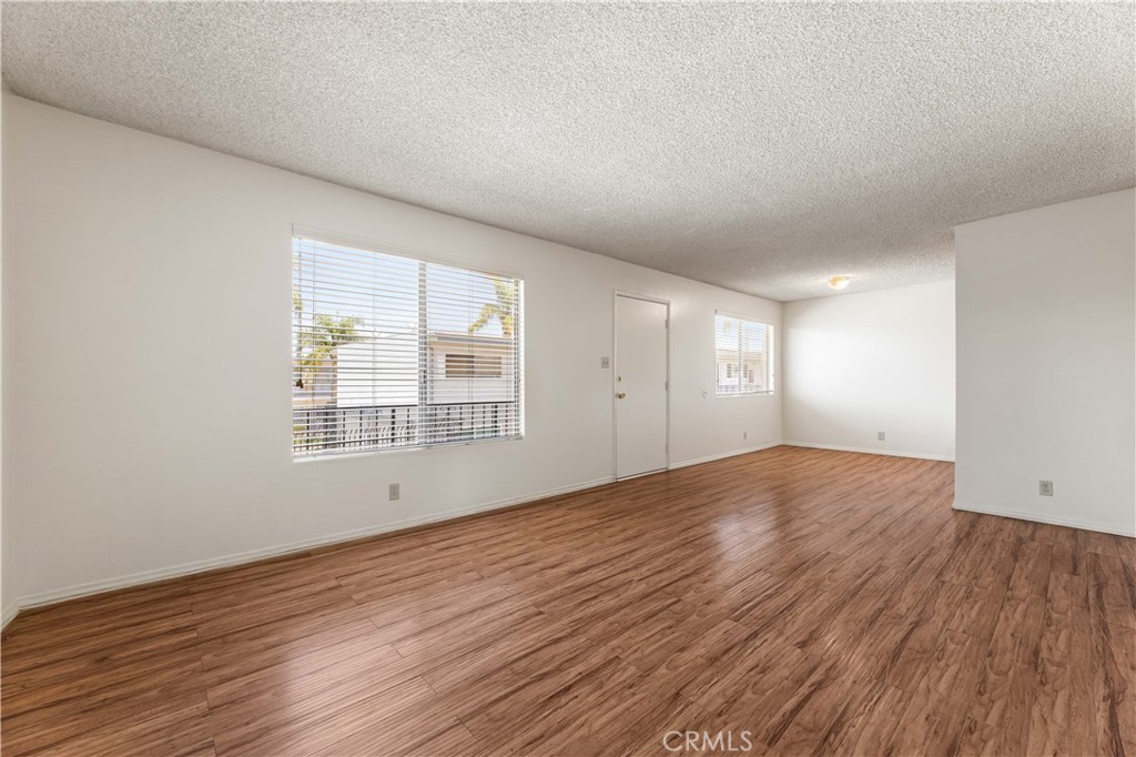 5530 Ackerfield Avenue, Unit 206 Long Beach, CA 90805 - Photo 2 of 33 a view of empty room with wooden floor and fan