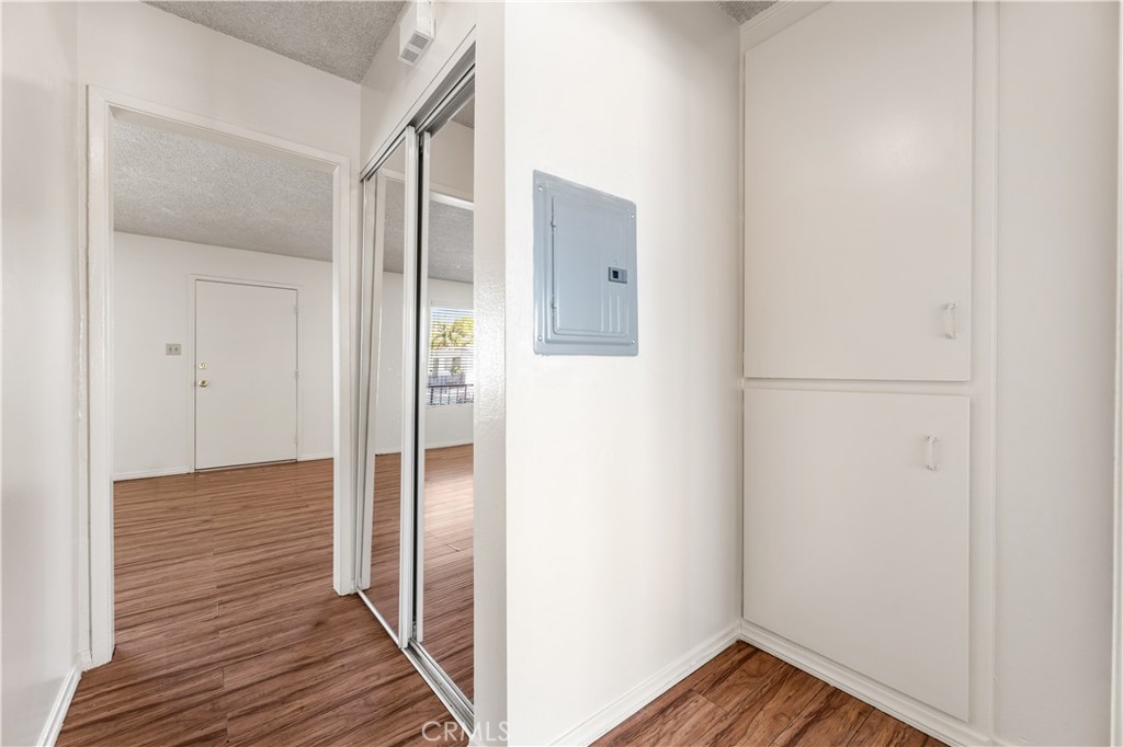 5530 Ackerfield Avenue, Unit 206 Long Beach, CA 90805 - Photo 21 of 33 a view of a hallway with wooden floor
