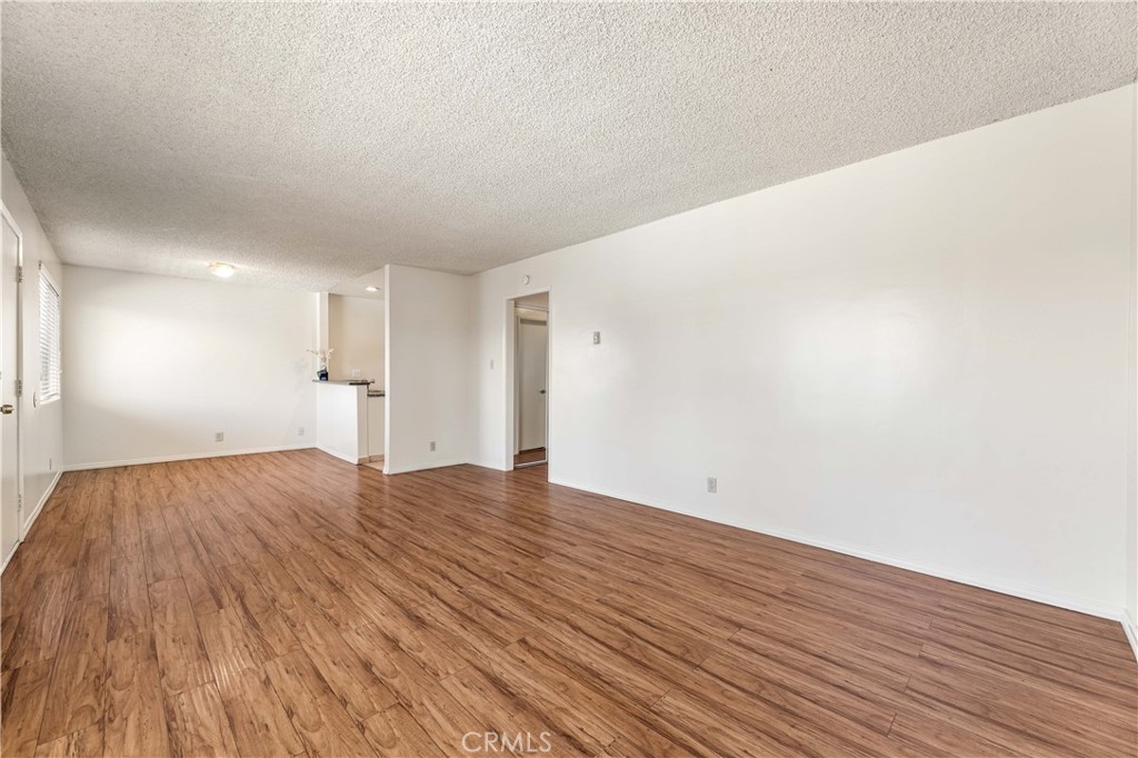 5530 Ackerfield Avenue, Unit 206 Long Beach, CA 90805 - Photo 3 of 33 a view of empty room with wooden floor