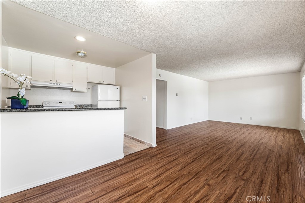 5530 Ackerfield Avenue, Unit 206 Long Beach, CA 90805 - Photo 5 of 33 a kitchen with wooden floor and window