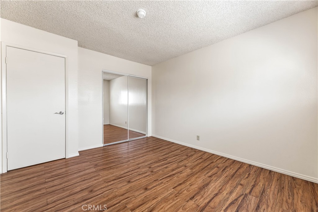 5530 Ackerfield Avenue, Unit 206 Long Beach, CA 90805 - Photo 10 of 33 a view of an empty room with wooden floor