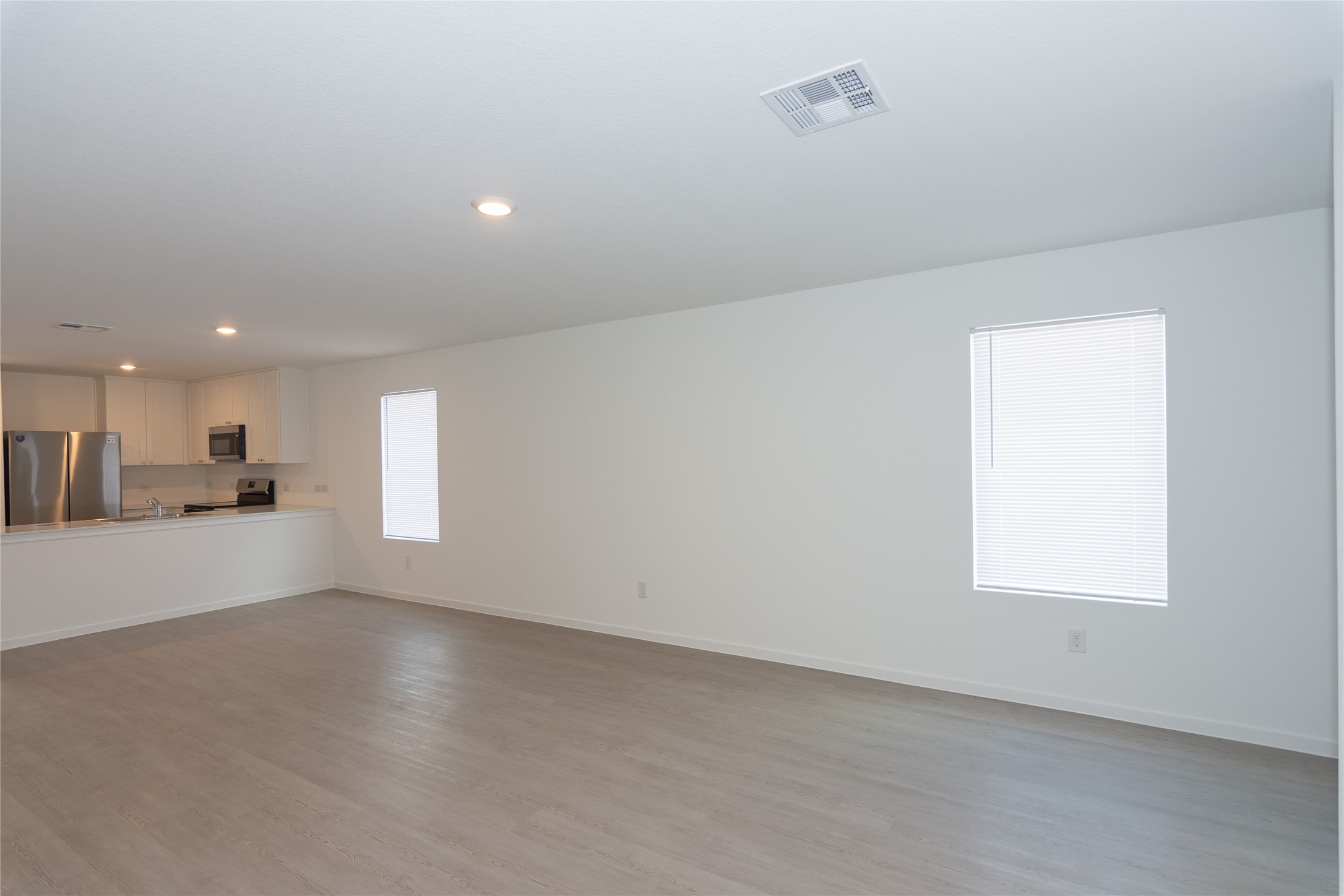 153 Star Packer Lane Jarrell, TX 76537 - Photo 28 of 30 An open floorplan seamlessly connects the kitchen and living areas, offering contemporary living.