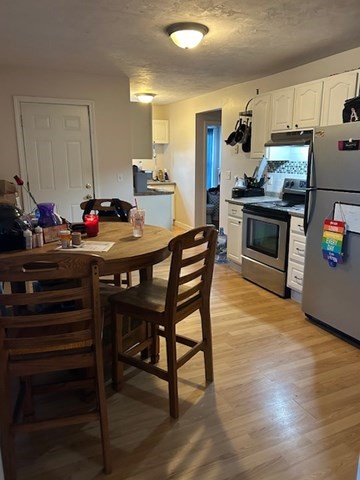 31 Goddard Street Webster, MA 01570 - Photo 19 of 31 a kitchen with a table chairs stove and cabinets