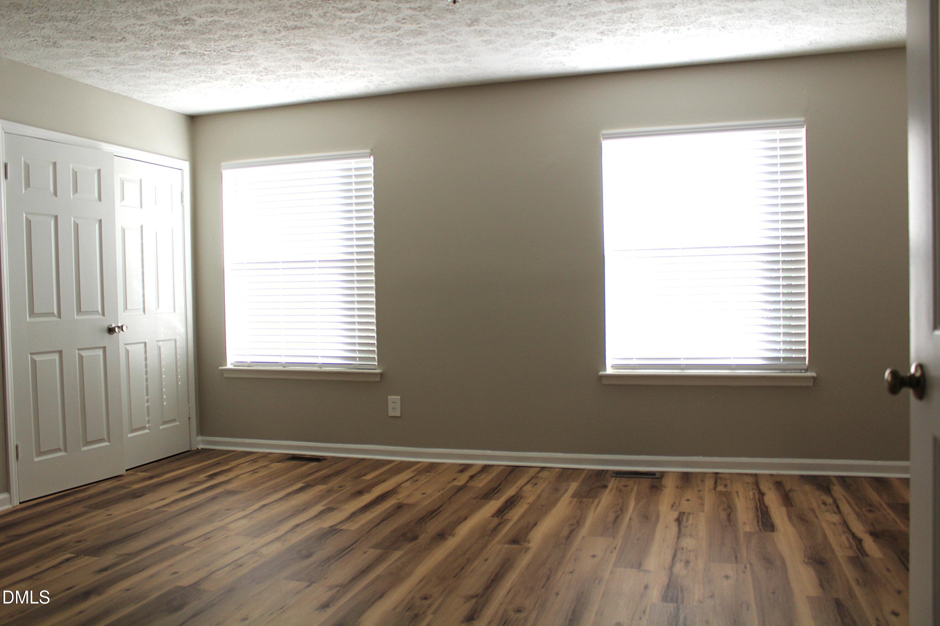 2706 Big Oak Street Raleigh, NC 27610 - Photo 11 of 11 a view of an empty room with wooden floor and a window