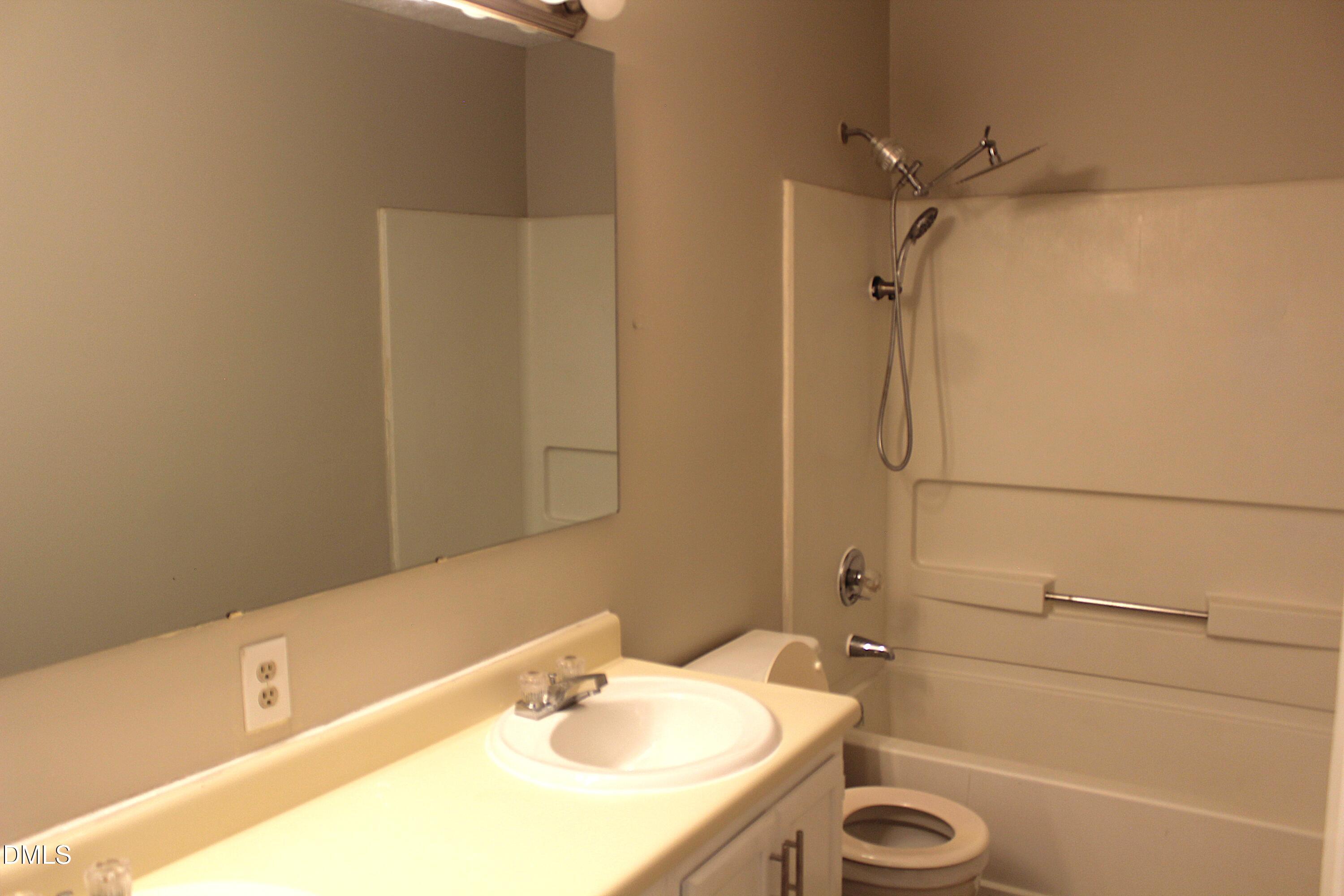 2706 Big Oak Street Raleigh, NC 27610 - Photo 3 of 11 a bathroom with a sink and a bathtub