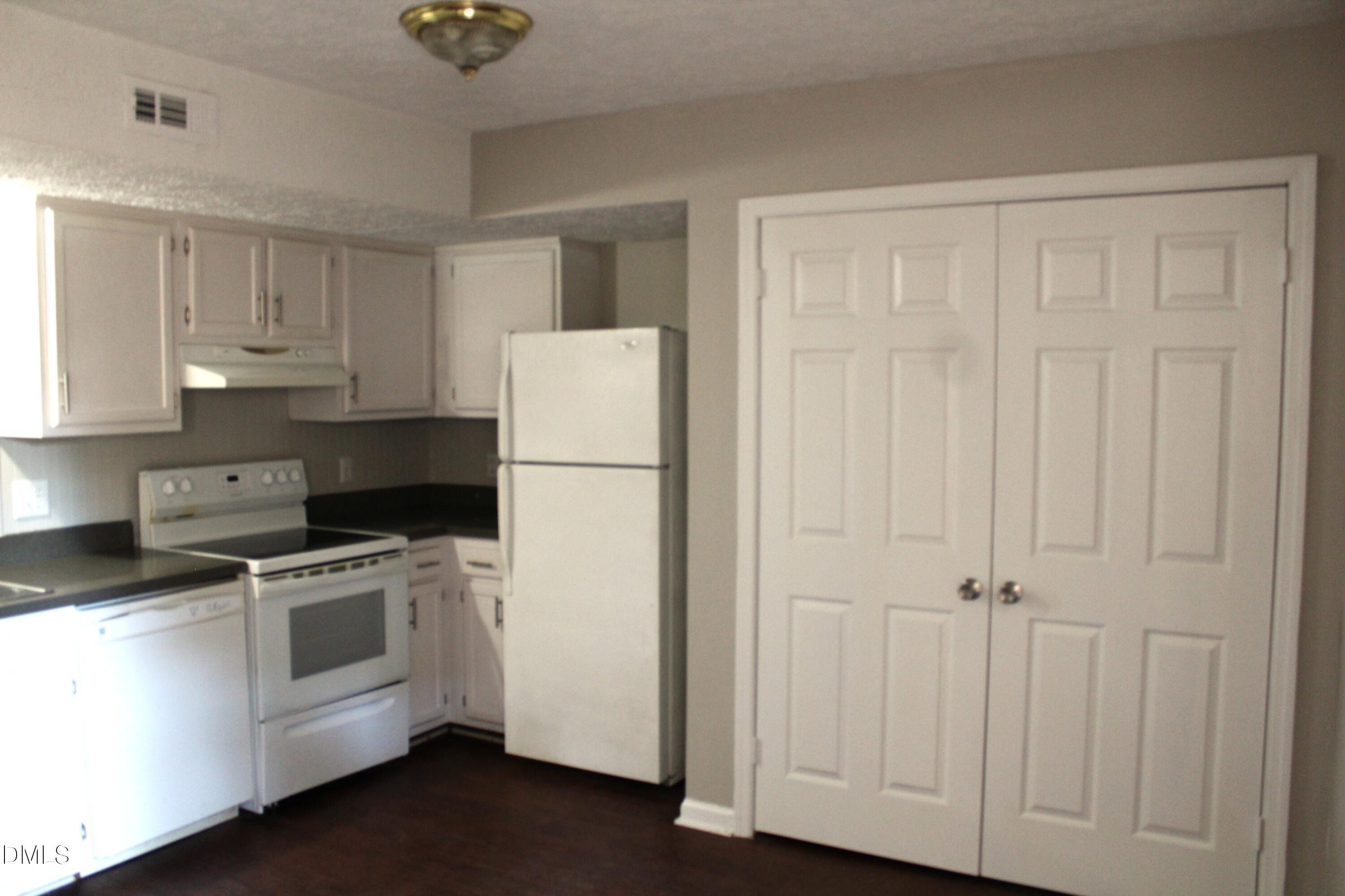 2706 Big Oak Street Raleigh, NC 27610 - Photo 6 of 11 a kitchen with a refrigerator sink stove and cabinets