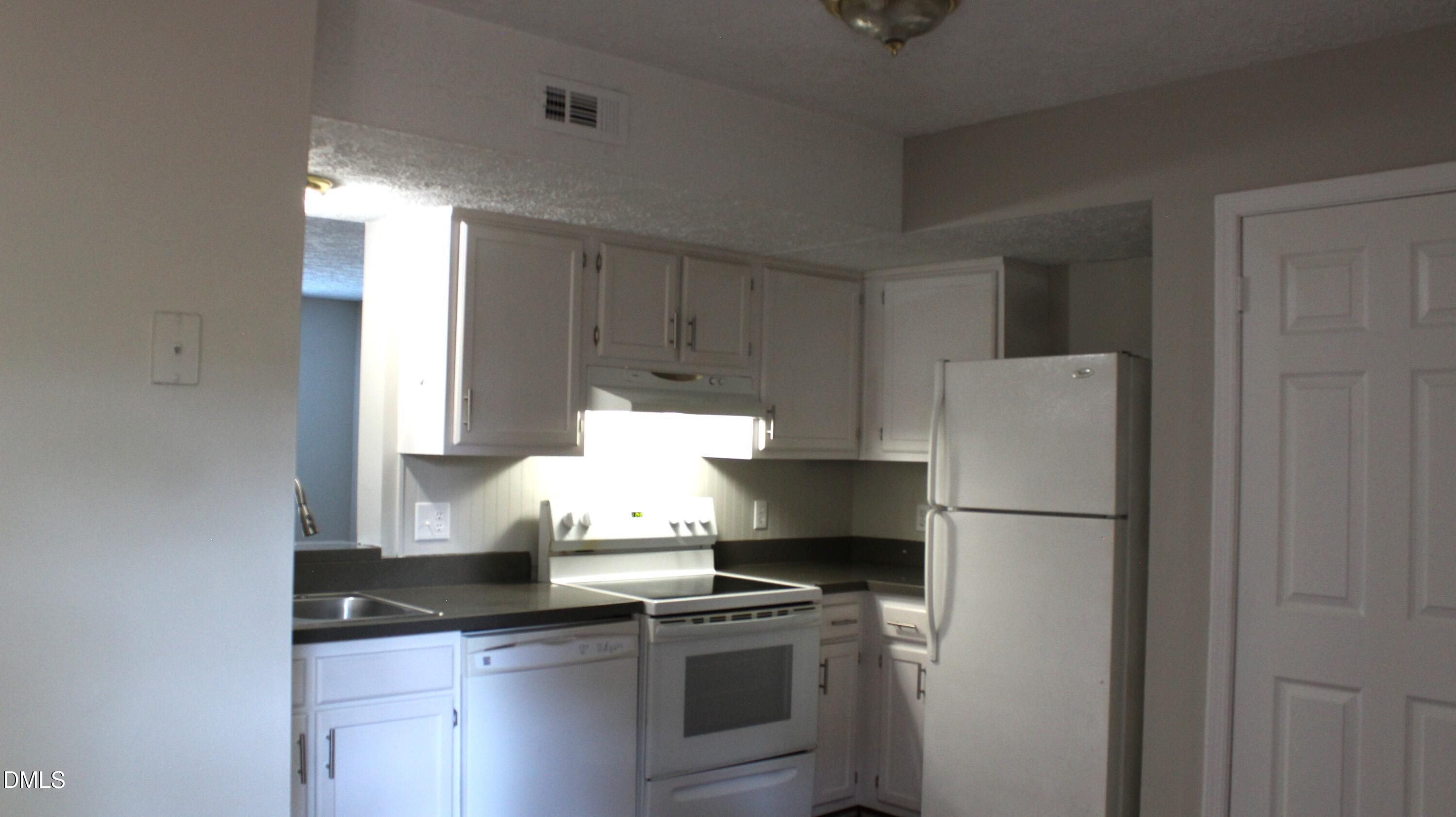 2706 Big Oak Street Raleigh, NC 27610 - Photo 7 of 11 a kitchen with stainless steel appliances granite countertop a refrigerator a stove and a sink