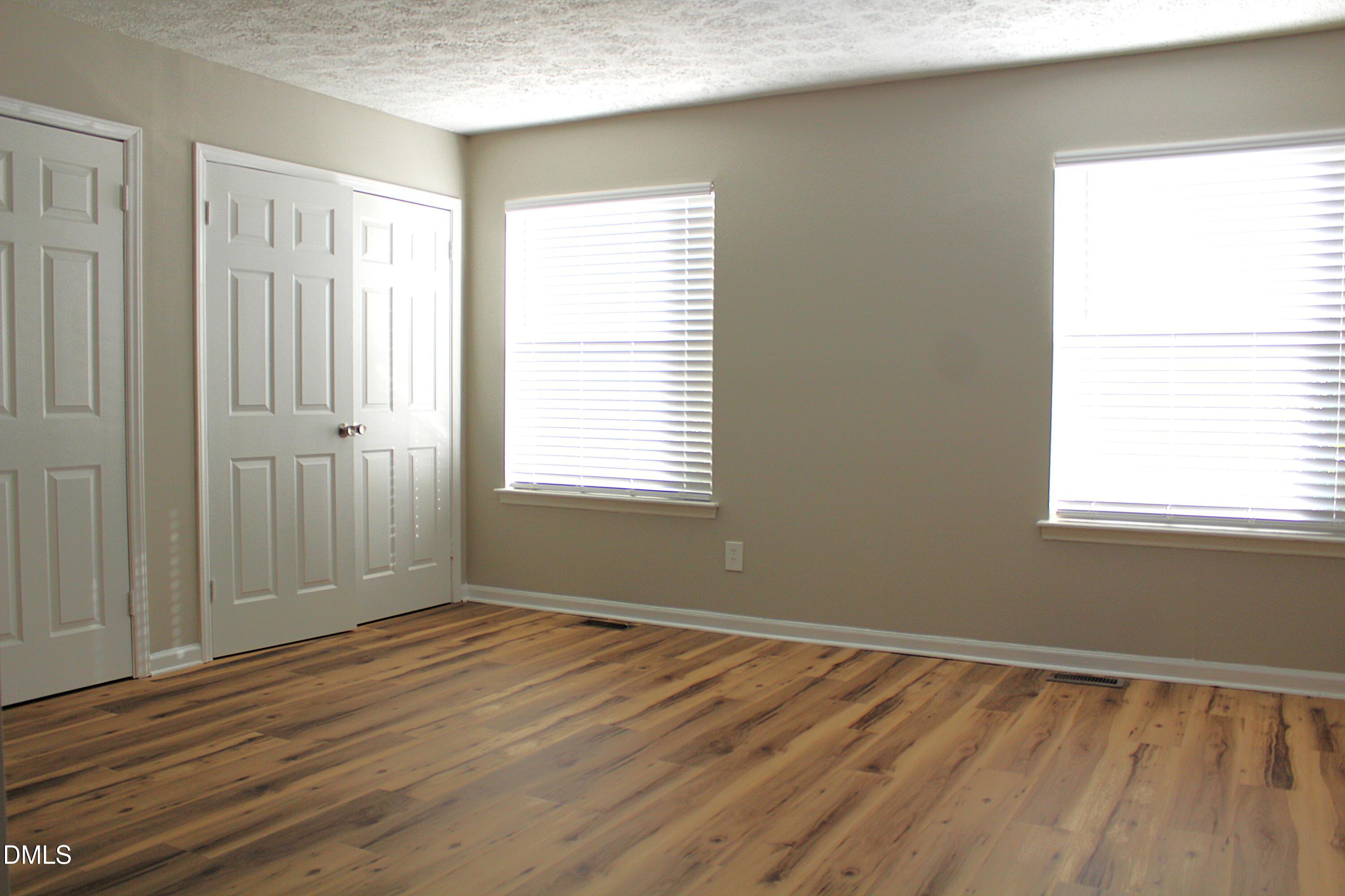 2706 Big Oak Street Raleigh, NC 27610 - Photo 9 of 11 a view of an empty room with wooden floor and a window