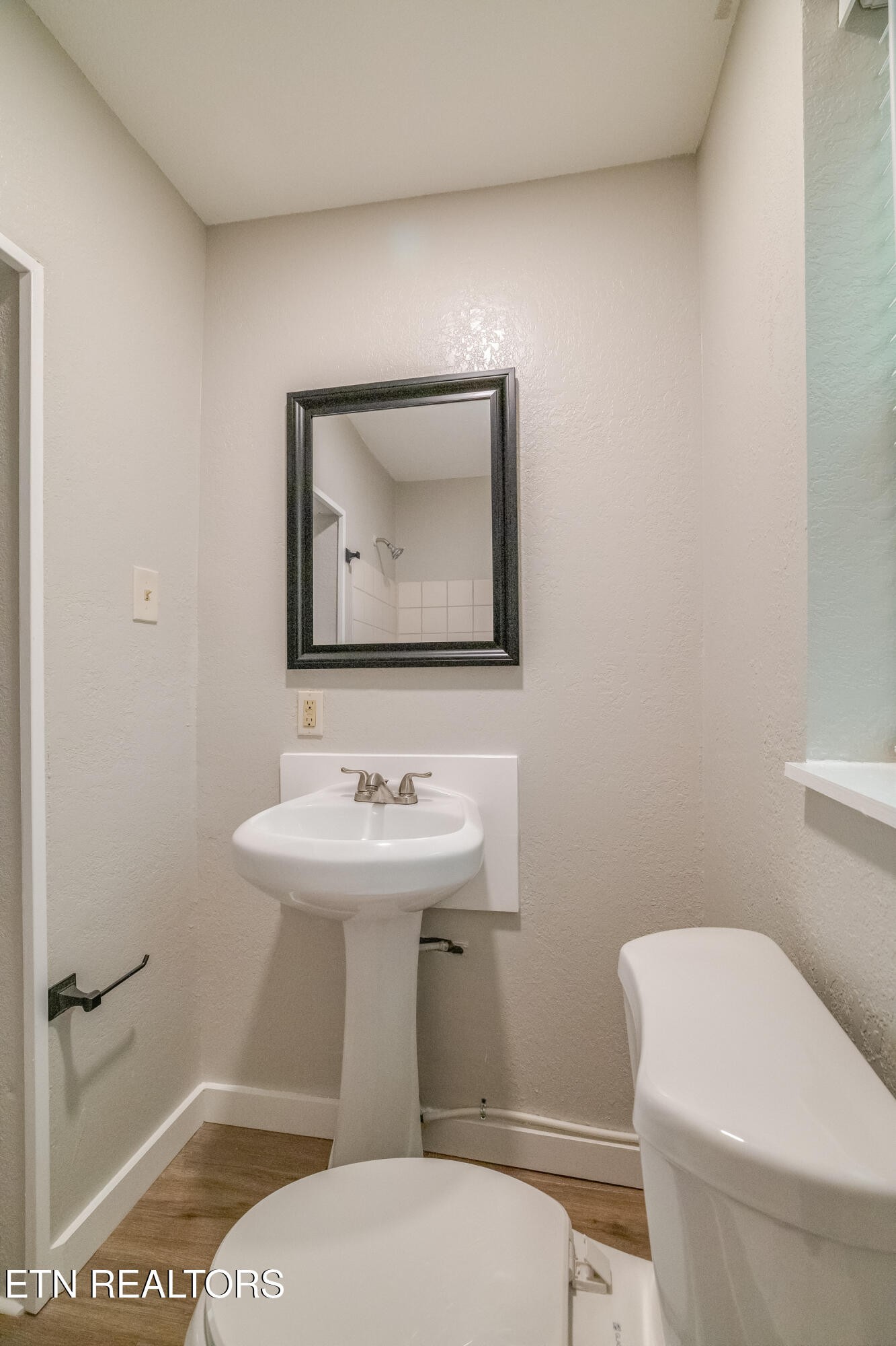 4707 Wildwood Road Maryville, TN 37804 - Photo 13 of 18 a bathroom with a toilet a sink and mirror