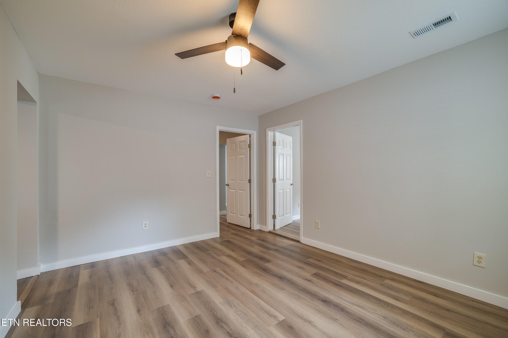 4707 Wildwood Road Maryville, TN 37804 - Photo 4 of 18 wooden floor in an empty room
