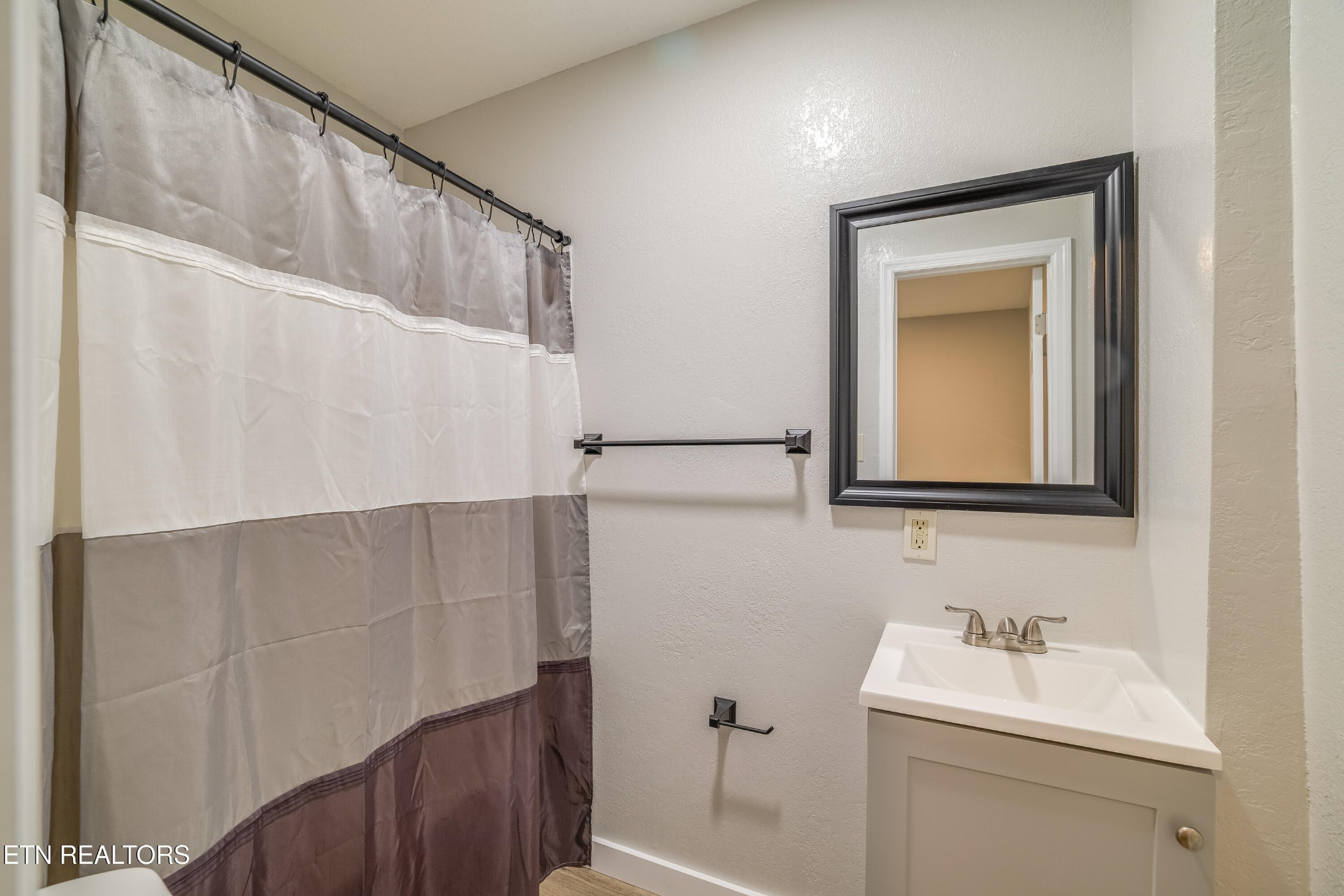 4707 Wildwood Road Maryville, TN 37804 - Photo 8 of 18 a bathroom with a sink a toilet and mirror