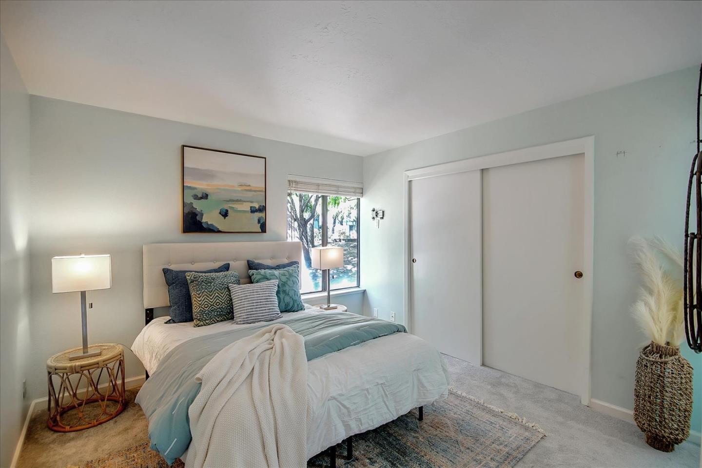 1925 46th Avenue, Unit 149 Capitola, CA 95010 - Photo 15 of 24 a bedroom with a bed and a lamp on table