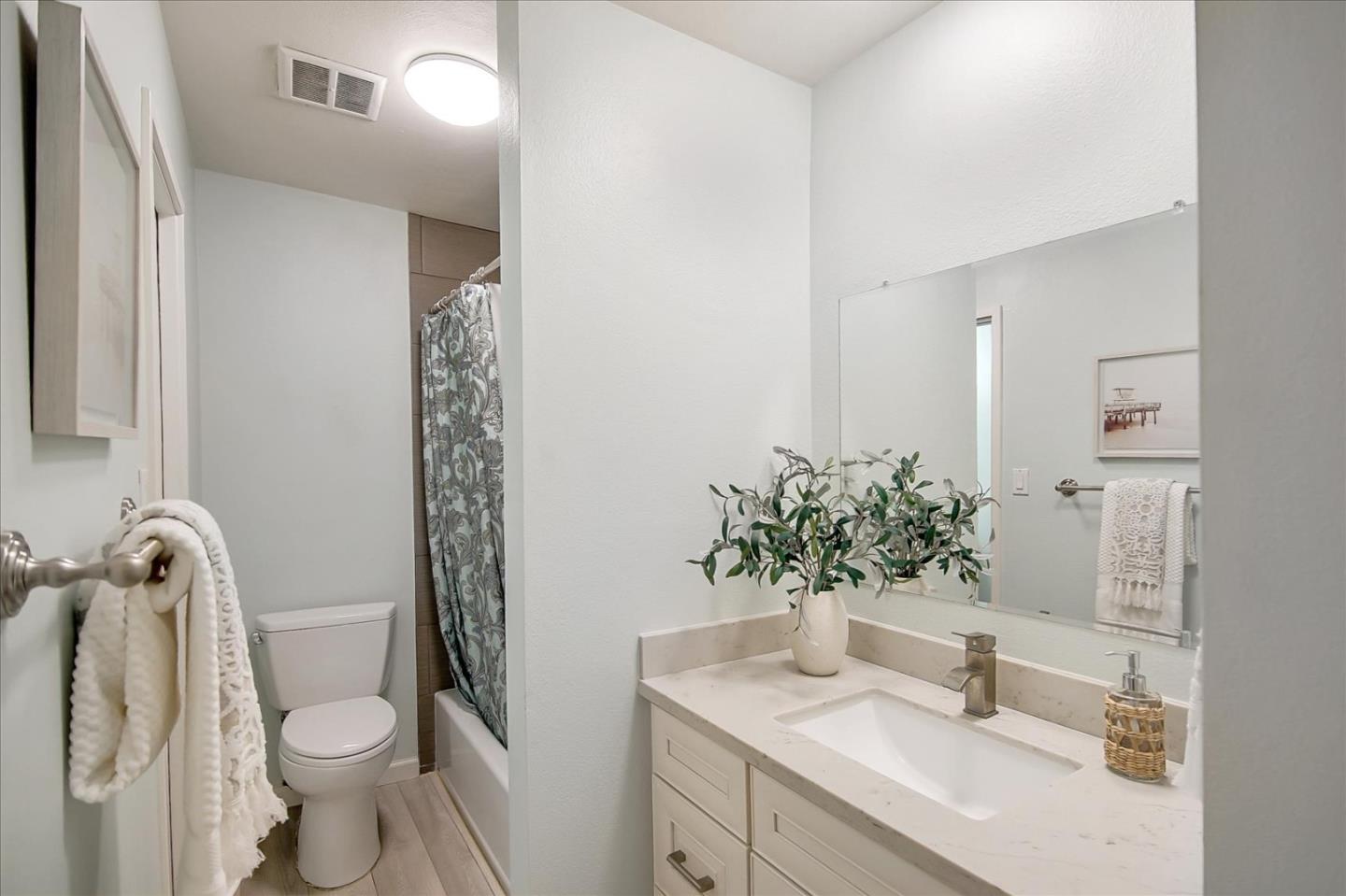 1925 46th Avenue, Unit 149 Capitola, CA 95010 - Photo 16 of 24 a bathroom with a granite countertop sink toilet and mirror