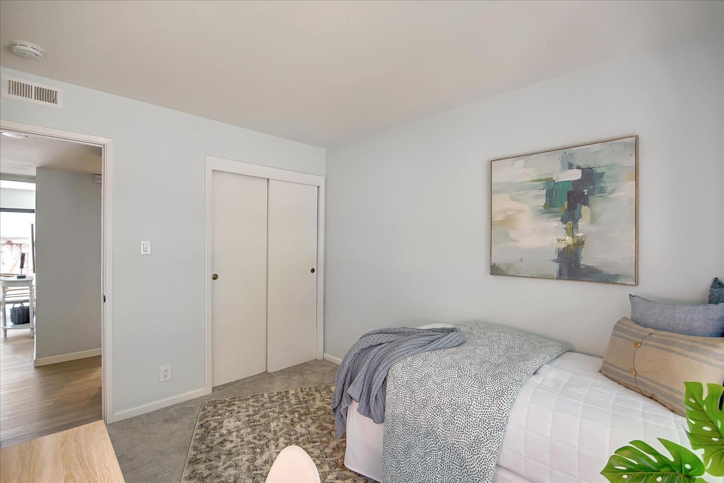 1925 46th Avenue, Unit 149 Capitola, CA 95010 - Photo 21 of 24 a bedroom with a bed and a painting on the wall