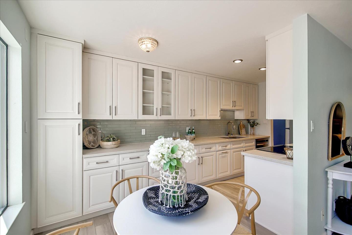 1925 46th Avenue, Unit 149 Capitola, CA 95010 - Photo 6 of 24 a kitchen with stainless steel appliances kitchen island granite countertop a sink a stove a dining table and chairs