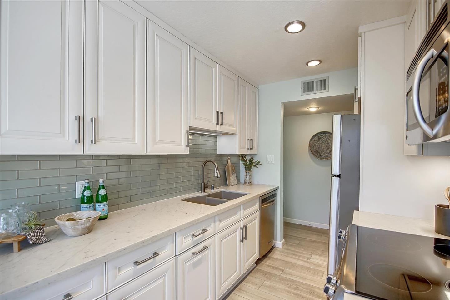 1925 46th Avenue, Unit 149 Capitola, CA 95010 - Photo 7 of 24 a kitchen with a sink and cabinets