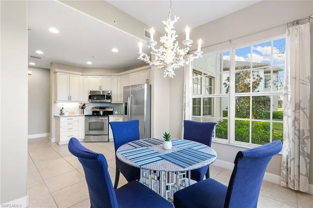 a view of a dining room with furniture a chandelier and wooden floor
