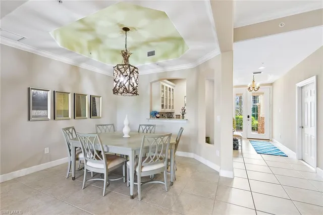 a view of a dining room with furniture and chandelier