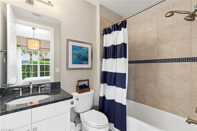 a bathroom with a sink a toilet tub and shower