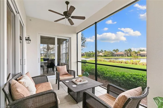 a living room with furniture and a floor to ceiling window