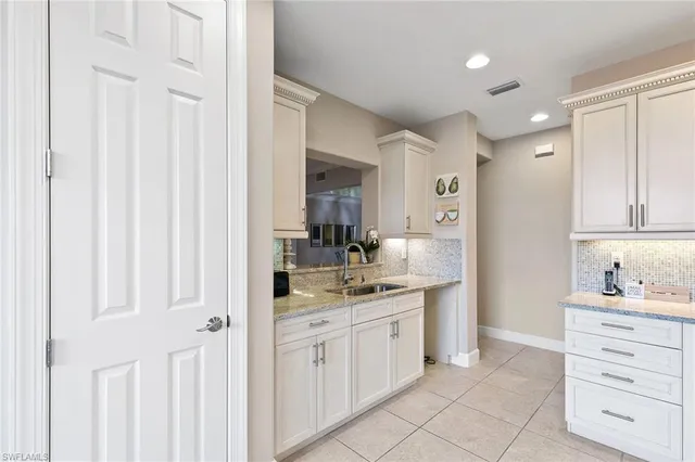 a bathroom with a granite countertop sink mirror and a