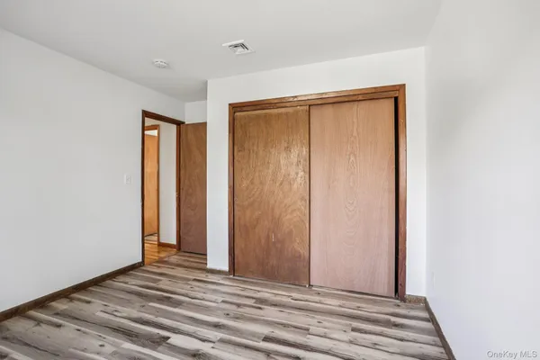 a view of a room with wooden floor and closet