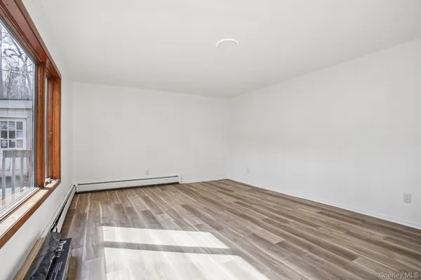 a view of a room with wooden floor and iron stairs