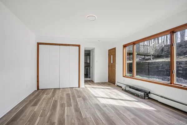 a view of a room with wooden floor and windows