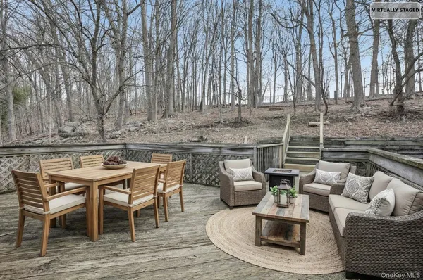a view of a patio with couches table and chairs and wooden floor
