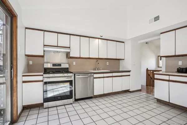 a kitchen with a stove top oven sink and cabinets