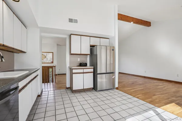 a kitchen with a refrigerator sink and cabinets