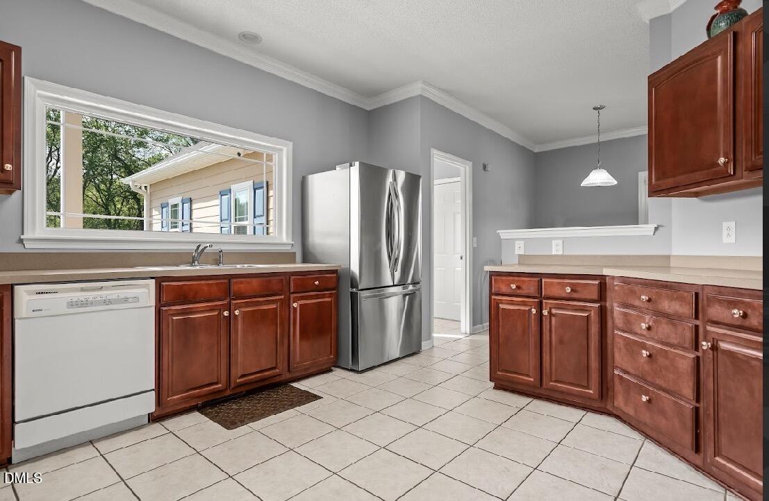 5780 McArthur Road Broadway, NC 27505 - Photo 15 of 40 a kitchen with stainless steel appliances granite countertop a refrigerator and wooden cabinets