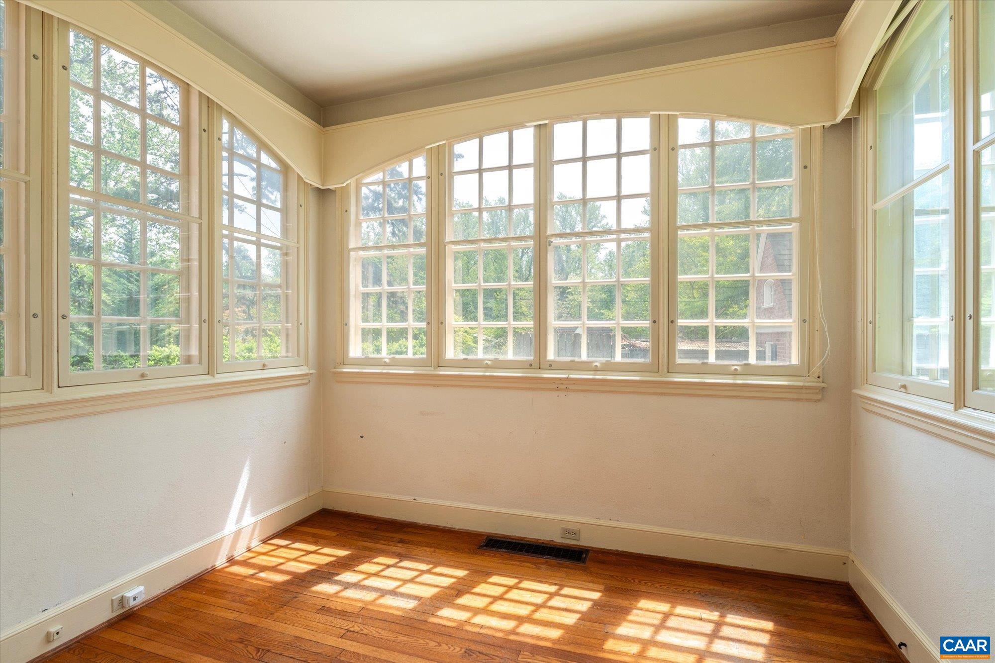 2001 Thomson Road Charlottesville, VA 22903 - Photo 12 of 54 a view of an empty room with wooden floor and a window
