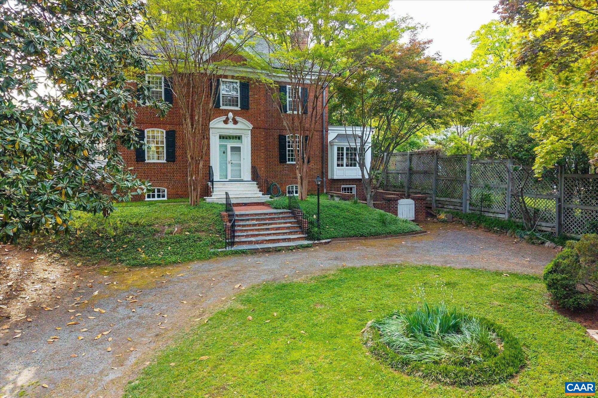 2001 Thomson Road Charlottesville, VA 22903 - Photo 4 of 54 a view of a brick house with a yard and large trees