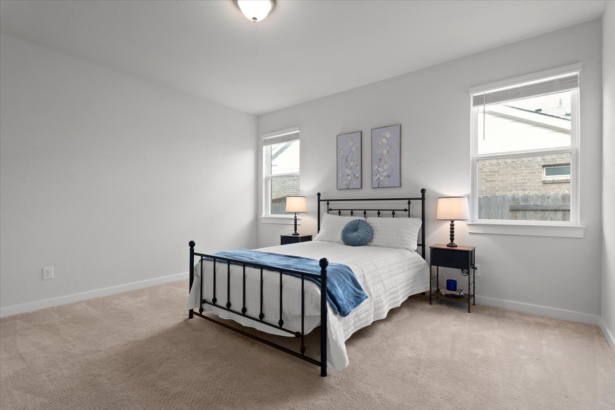 321 Buffalo View Lane Georgetown, TX 78628 - Photo 11 of 29 Light-colored carpet and two large windows help bring in the natural light