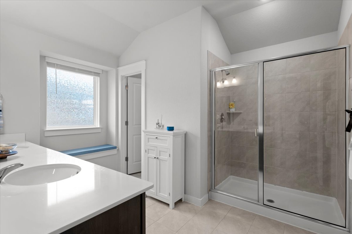 321 Buffalo View Lane Georgetown, TX 78628 - Photo 13 of 29 Spacious shower with a glass enclosure, and a large window providing natural light